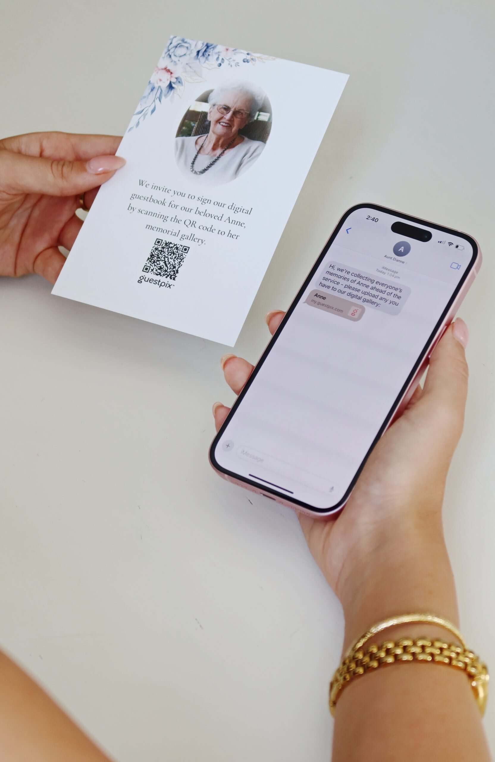 Card held in hand inviting guests to scan a QR code for a digital guestbook, with a portrait and floral corner on the card.