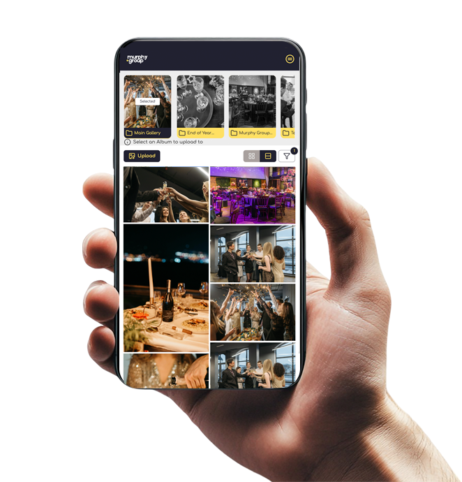 A hand holding a smartphone displaying the GUESTPIX event photo sharing app with images of social gatherings and parties.