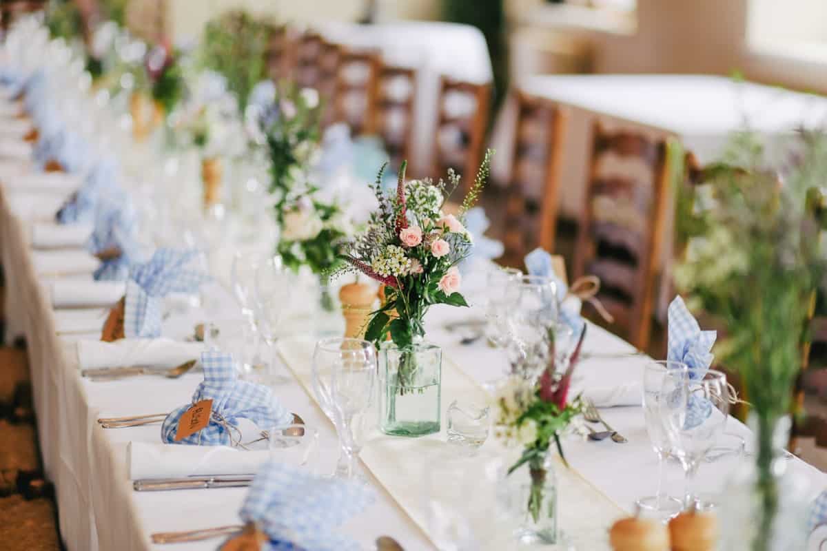 Elegant event table setting with beautiful decorations and floral centerpieces.