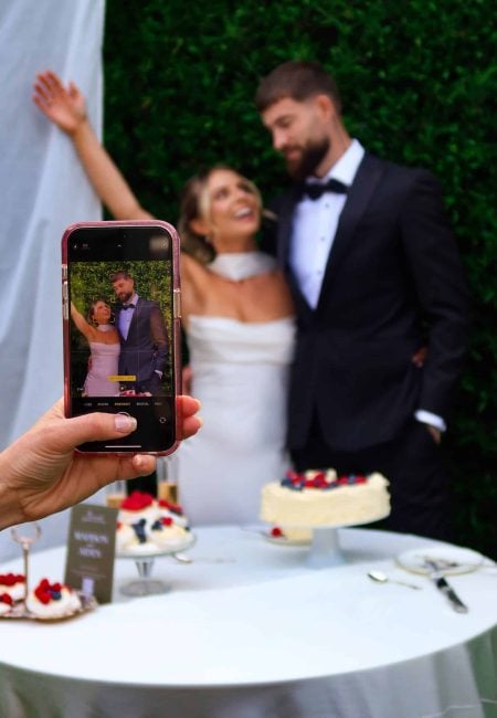 Wedding Guest Taking Photos of Couple