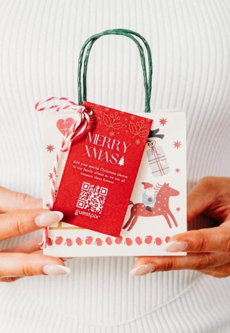 Festive Christmas gift bag with a QR code, featuring holiday-themed decorations including a reindeer and snowflakes, perfect for holiday celebrations and event photo sharing.
