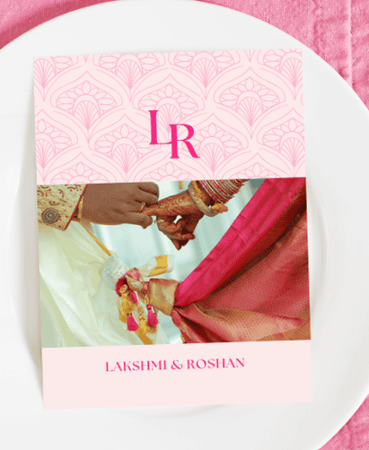 Hochzeitseinladung für Lakshmi &amp; Roshan mit einem rosa dekorativen Hintergrund, dem Monogramm „LR“ und einem Motiv mit verschränkten Händen.
