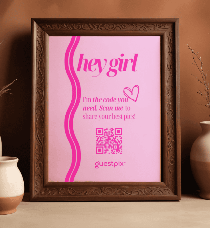 Poster rosa incorniciato con la scritta “hey girl”, un cuoricino e un codice QR, che ti invita a condividere le tue foto più belle.