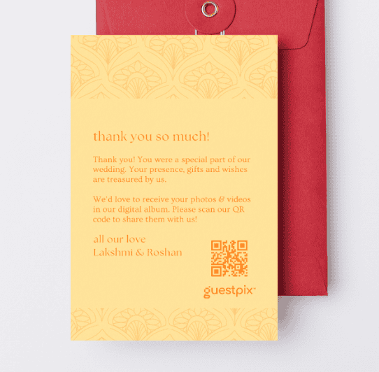 Tarjeta de agradecimiento de boda con un motivo decorativo naranja, un degradado amarillo, el texto «Gracias» y un código QR para compartir fotos en Guestpix, dentro de un sobre rojo.